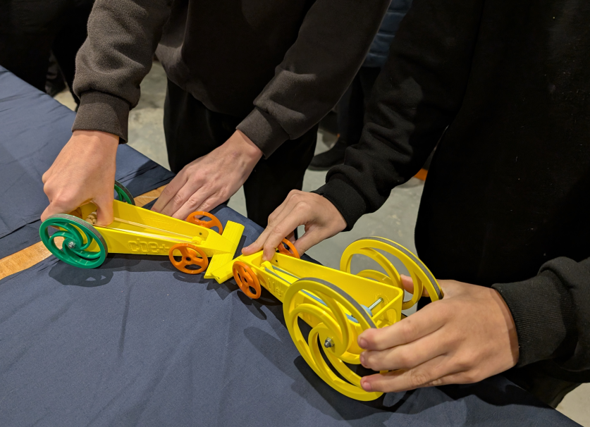 A picture of 2 students building a model car kit