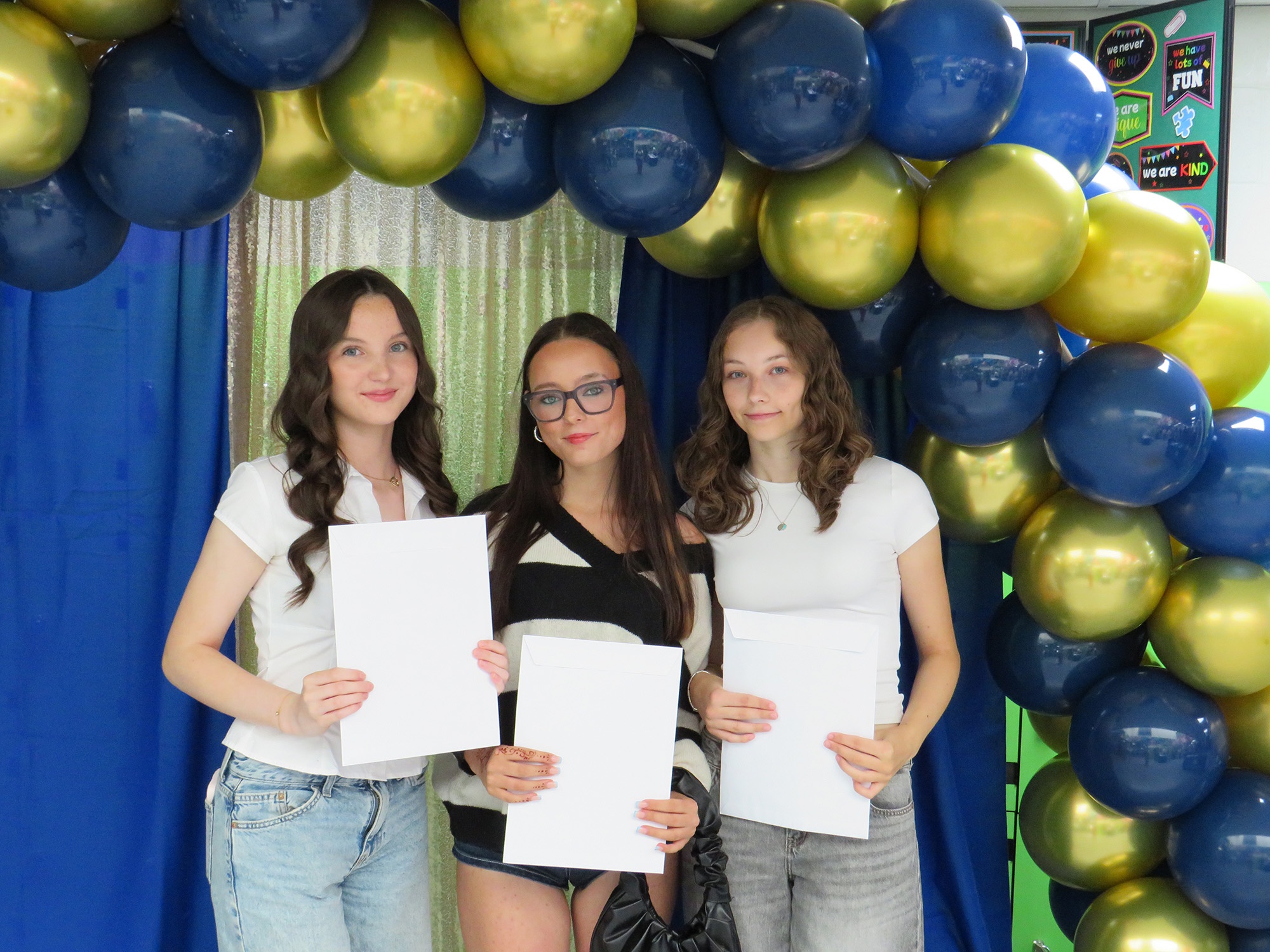 Three Westfield students celebrating their GCSE results