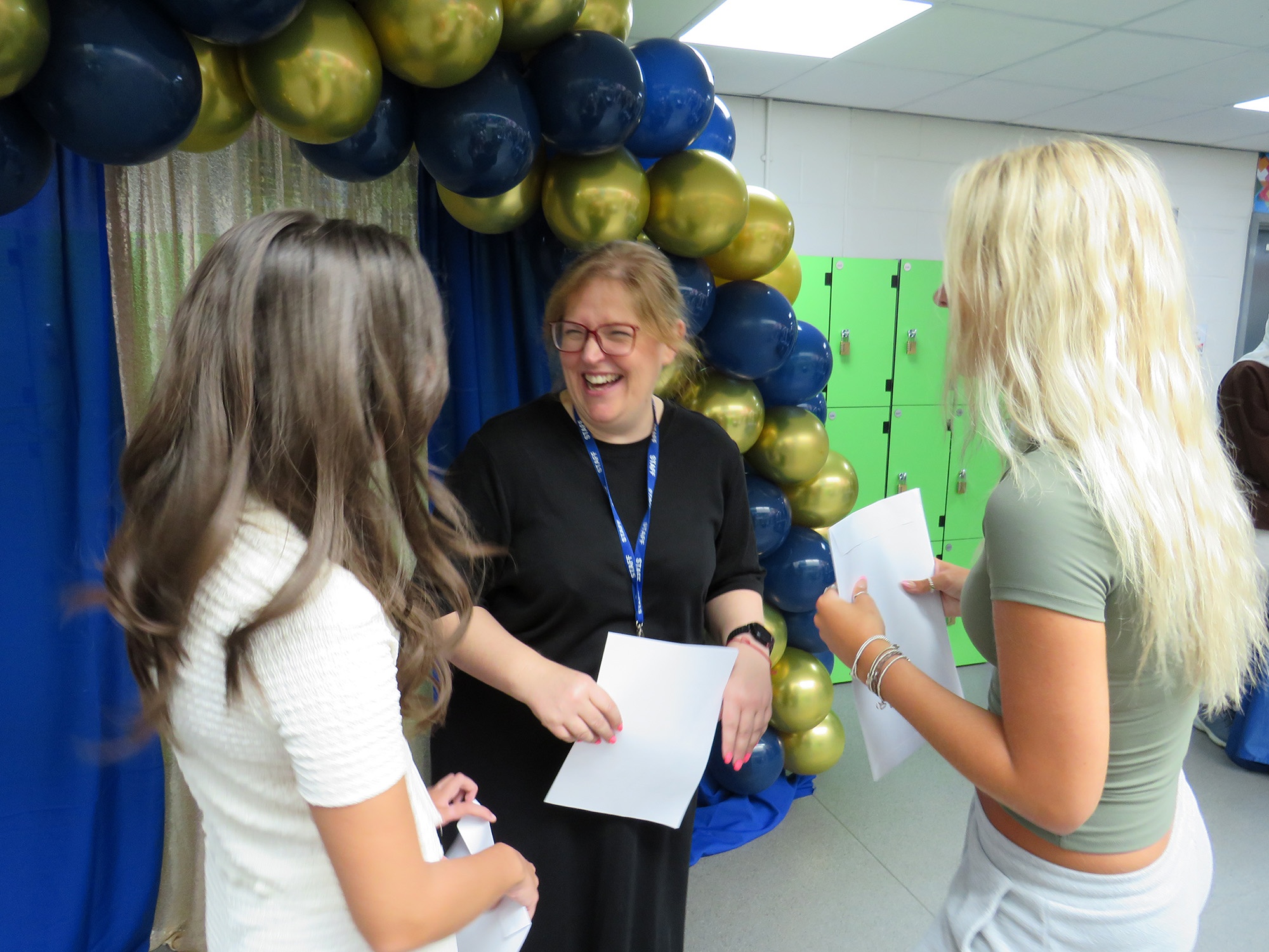 Staff and students celebrating GCSE results
