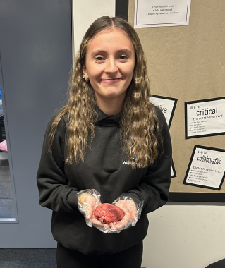 A student holding an animal heart