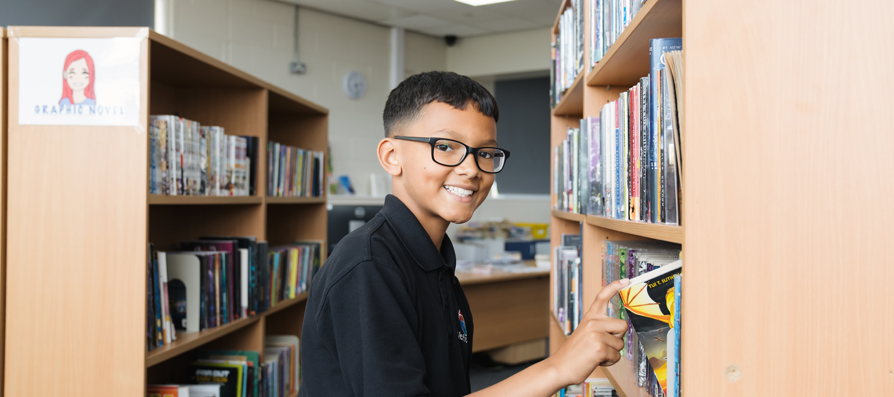 A student choosing a library book